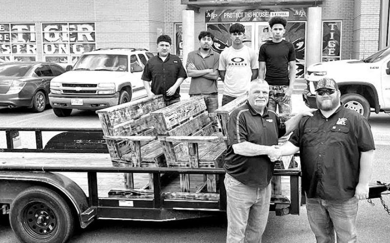 City of Mount Pleasant Public Works Director Garrett Houston (front right) picks up the new benches for Dellwood Park from MPHS Construction teacher Jim Alston (front left) and some of the MPHS Construction students COURTESY PHOTO