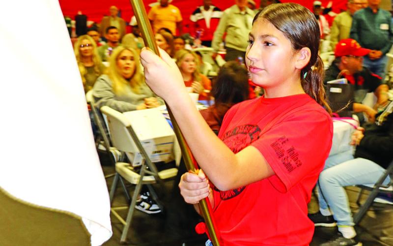Braylee Noguera presents the United States Army flag