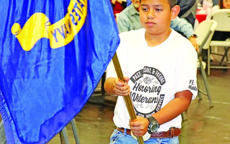 Camilo Ramirez presents the United States Navy flag