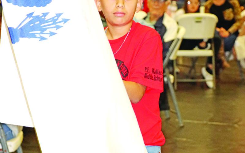 Kelvin Garcia presents the U.S. Coast Guard flag