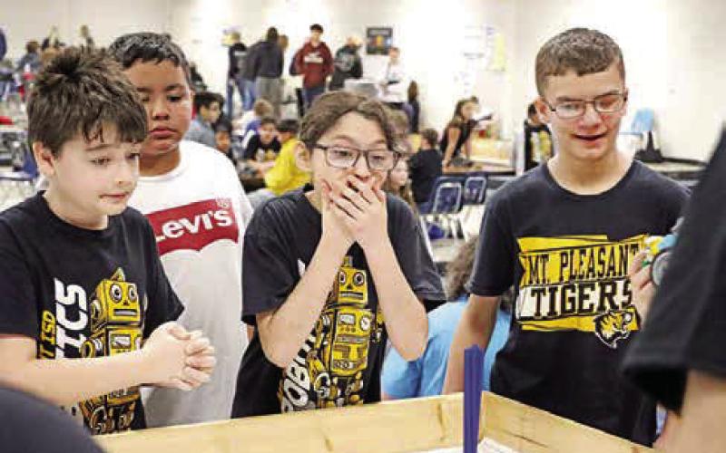 (L to R) Jake Jones, Krystopher Castro, Tana Contreras, and Teyten Mettlen of Wallace Pizza cheer on their robot during the semifinals round.