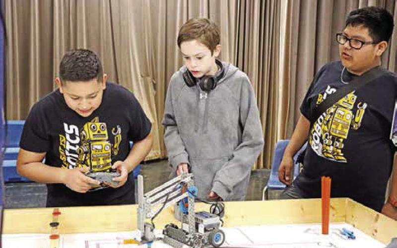 The MPJH Hamburgers (L to R) Heymar Rivera, Aiden Lane, and Omar Castaneda maneuver their robot during the driver-controlled period.