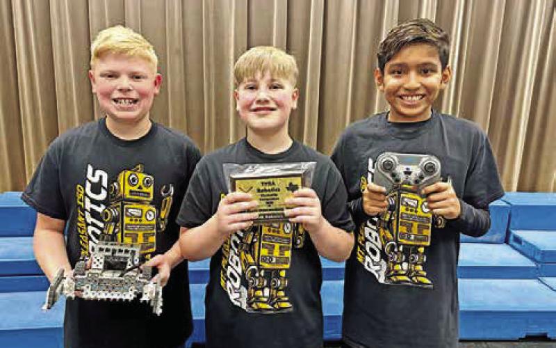 Carter Cameron, Thatcher Drange, and Kael Aleman of the Wallace Texas Stars with their robot and 2nd place plaque. COURTESY PHOTOS