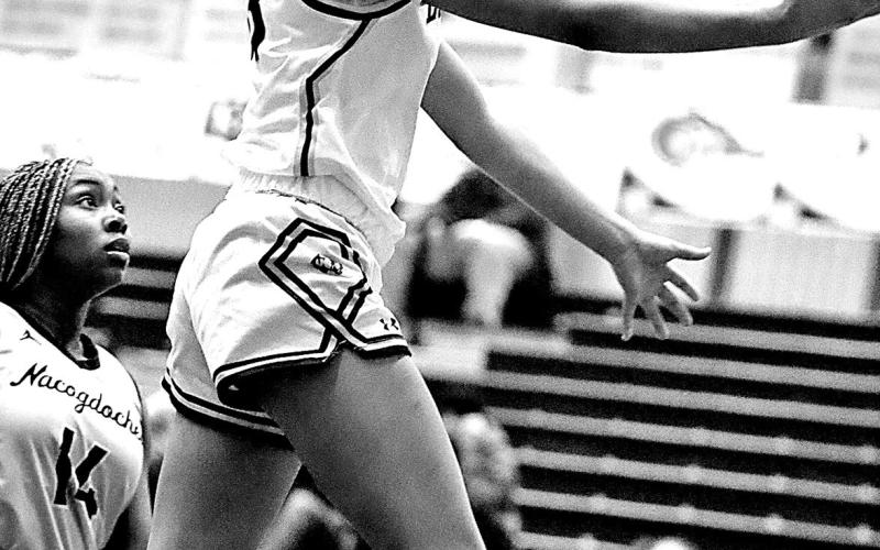 A Lady Tiger knifes through the defense, attacking the lane with confidence as Mt. Pleasant’s pressure and pace overwhelmed Nacogdoches.