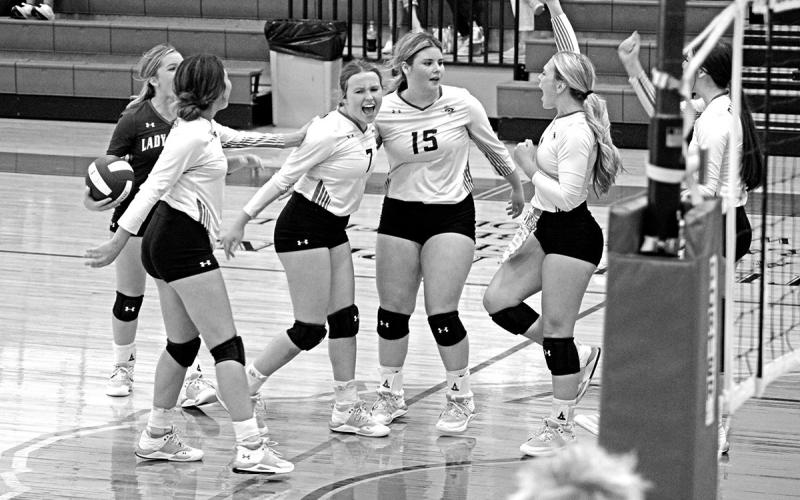 From left, Rivercrest’s Diana Kelley, Logan Huddleston, Alexis Case, Elizabeth Langehennig, Vivian Hines and Kynzie Franks celebrate a point during a recent match. The Lady Rebels took on Como-Pickton Tuesday evening and open district next week at Harts Bluff. TRIBUNE PHOTO / QUINTEN BOYD