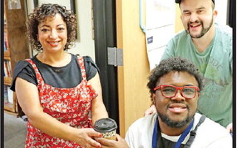 Ghyles Lias and Cole Ashley deliver coffee to Eva Beles.