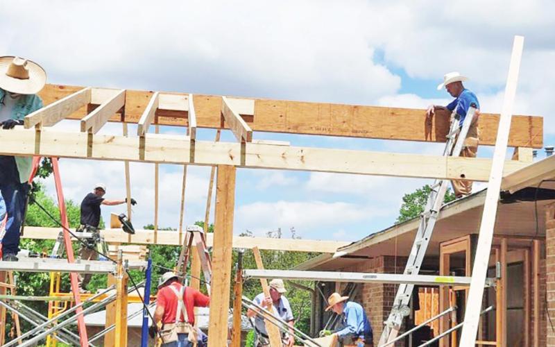 Workers with Volunteer Christian Builders work on one of the buildings that they helped renovate for Hope Ministries during their two weeks here in Mount Pleasant. COURTESY PHOTO