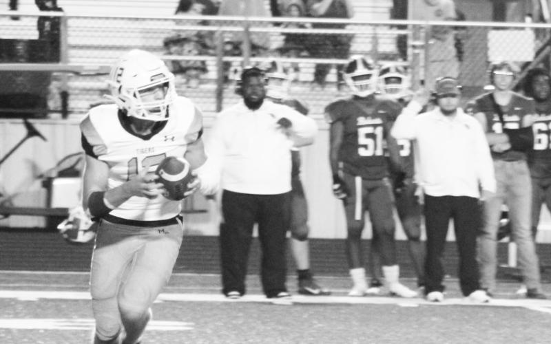 Keller Thompson rolls out looking for a receiver during a recent game. Thompson had 186 yards passing in the Tigers’ 24-21 loss to Marshall Friday. Mount Pleasant travels to Pine Tree this week. TRIBUNE PHOTO / QUINTEN BOYD