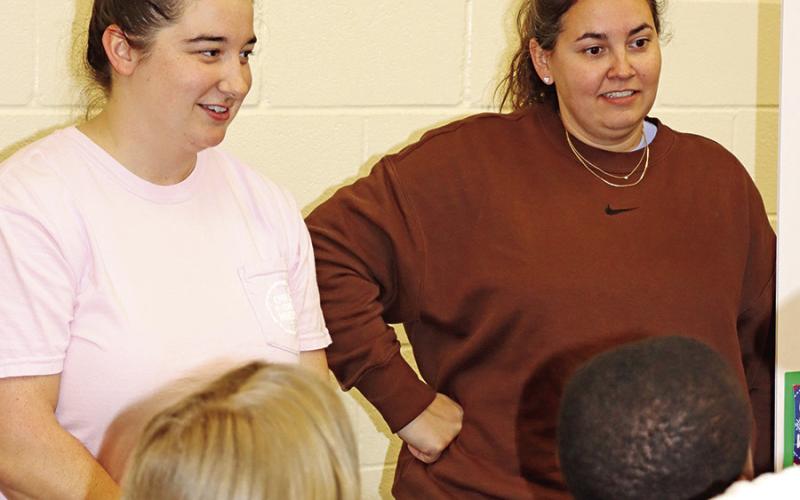 Rachel Narramore listen as a student asks how many snow cone flavors they offer