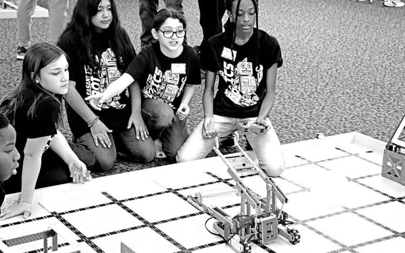 Wallace Team 4 member Kezia Williams (right) passes the ball while team members Paisley Hamilton, Allison Castaneda, and Tana Contreras (L to R) look on