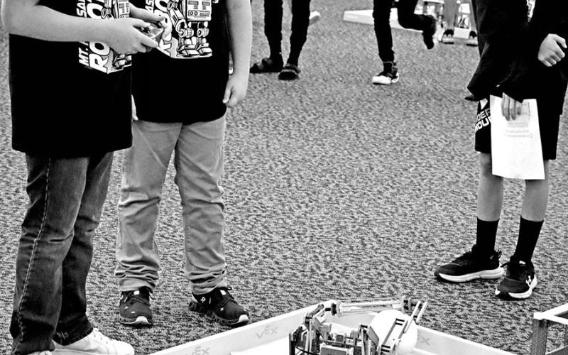 Wallace Team 3 member Carter Cameron (left) drives the robot as Thatcher Drange and Lane Richardson watch