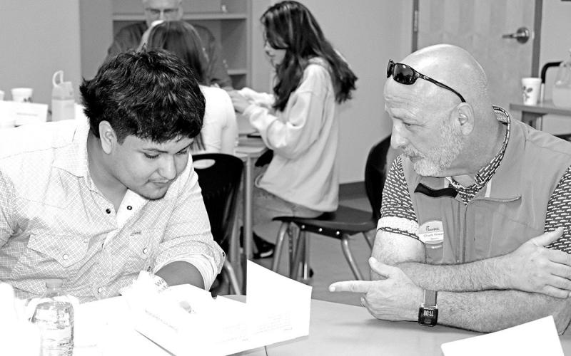 Chick-Fil-A Owner/Operator, Chuck Howard (right), gets to know MPHS senior, David Cumpian, over lunch