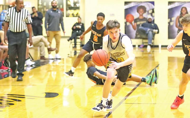 A Tiger drives the ball up the court. COURTESY PHOTO
