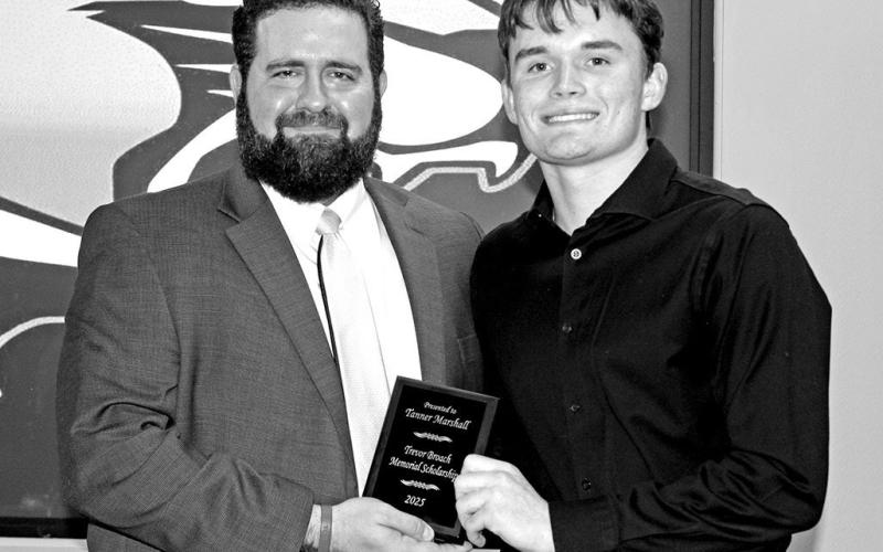 Tanner Marshall (right) receives the Trevor Broach Memorial Scholarship from PISD Athletic Director and Head Football Coach, Joey Cluley COURTESY PHOTO / SONYA WOODS AT TRICOUNTY PRESS: