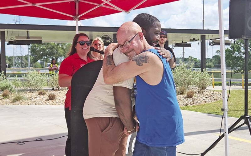 Brandon Minter shares a hug with the man he saved in a wreck