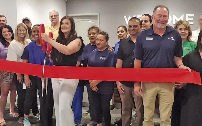 The red ribbon is snipped for the re-opening of Hampton Inn TRIBUNE PHOTOS / NICOLE KIMBALL