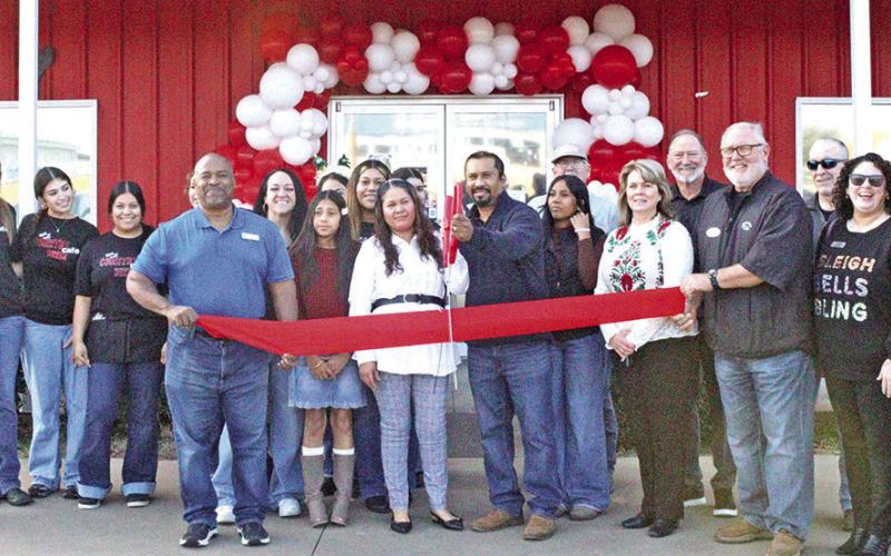 Owner of Country Cafe Diner, Uriel Sanchez, cuts the ribbon at ceremony.