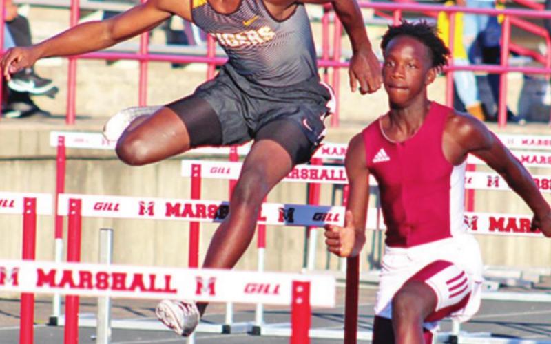 Isaiah Hunter competes in the hurdles.