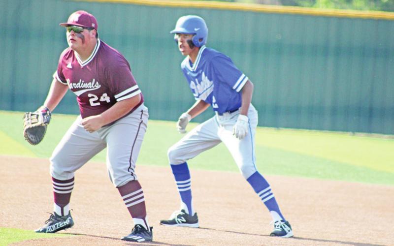 Rivercrest’s Tre Williams prepares to run as Maud’s Evan Acosta sets up defensively during game one of the regional quarterfinal series between the Rebels and Cardinals. Maud won game one, 14-4, but Rivercrest bounced back to win game two, 6-2. Game three is Saturday at Winnsboro’s The Ballpark at Raiderland. TRIBUNE PHOTO / QUINTEN BOYD