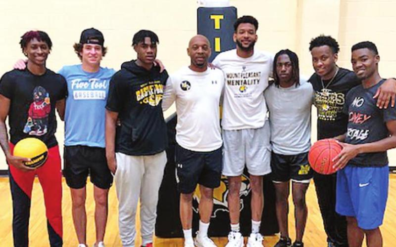 Former Tiger basketball players returned to serve their community. Pictured L-R: Zaveion Chism-Okoh, Brock Cooper, Xzavier Brown, Coach Joey Chism, Christon Himes, Jakybrein Hines, Devin Williams, Josh McGill