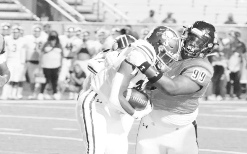 Defensive end Tre Emory takes down a Pine Tree runner last season. COURTESY PHOTO / JOHN WHITTEN