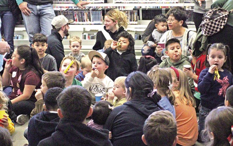 Children played with noisemakers as they eagerly awaited for noon.