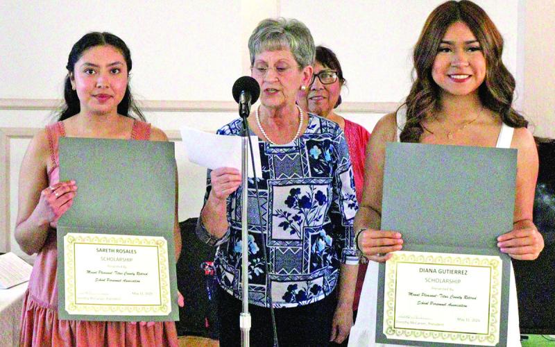 Sue Parker presents scholarships to Sareth Rosales (left) and Diana Gutierrez (right)