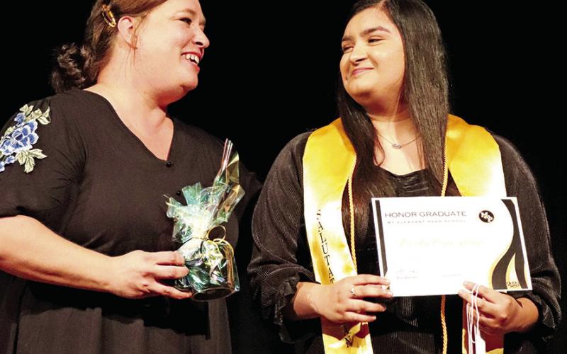 Class of 2023 Salutatorian Perla Guzman exchanges a smile with her honored teacher Julie Wade (left)