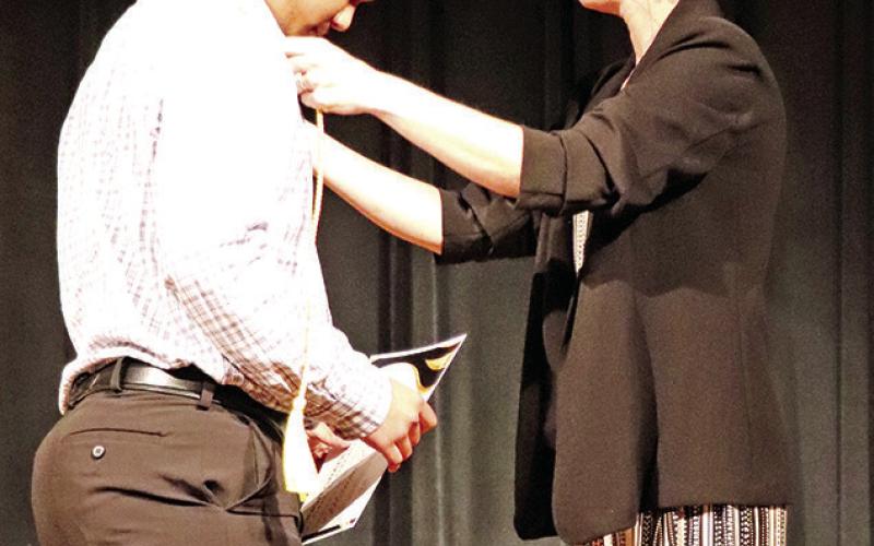 Manoa Bagsic receives his honor graduate cord from Mandy Jones, MPHS Class of 2023 counselor