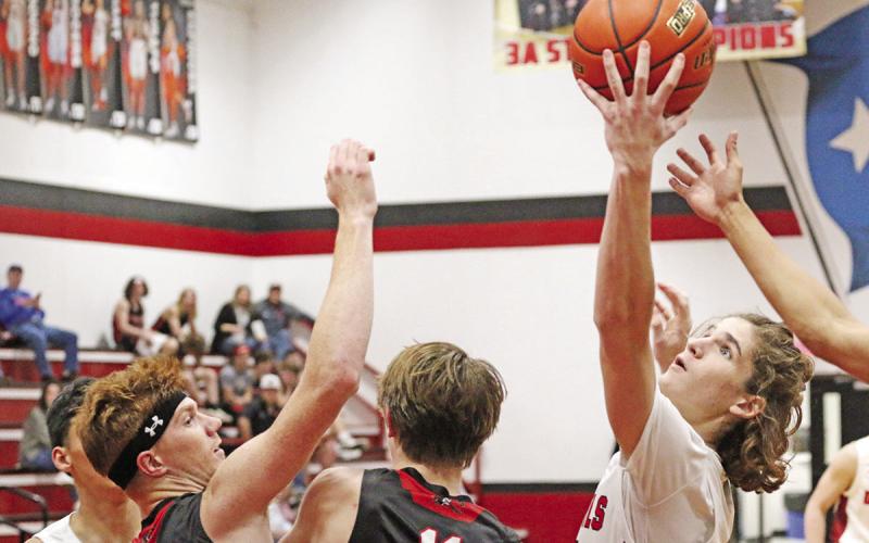Isaac Bailey pulls in a rebound during Tuesday’s game. The eighth-ranked Red Devils defeated the Red Raiders, 59-33. TRIBUNE PHOTO / QUINTEN BOYD