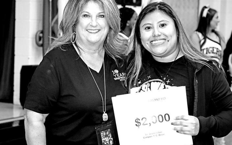 Tonya Murray presents a grant for an interactive Smart Board to Brice teacher, Jessica Soc