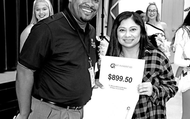 Chaz Curtis gives Fowler teacher, Manuela Ramirez-Sarabia, a grant for for flexible seating for her classroom