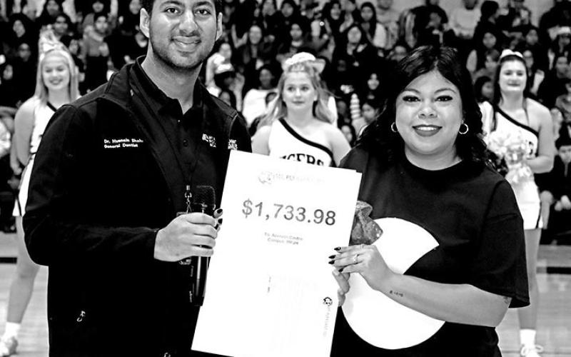Dr. Husnain Shahid presents a grant to MPJH teacher, Azeneth Castro