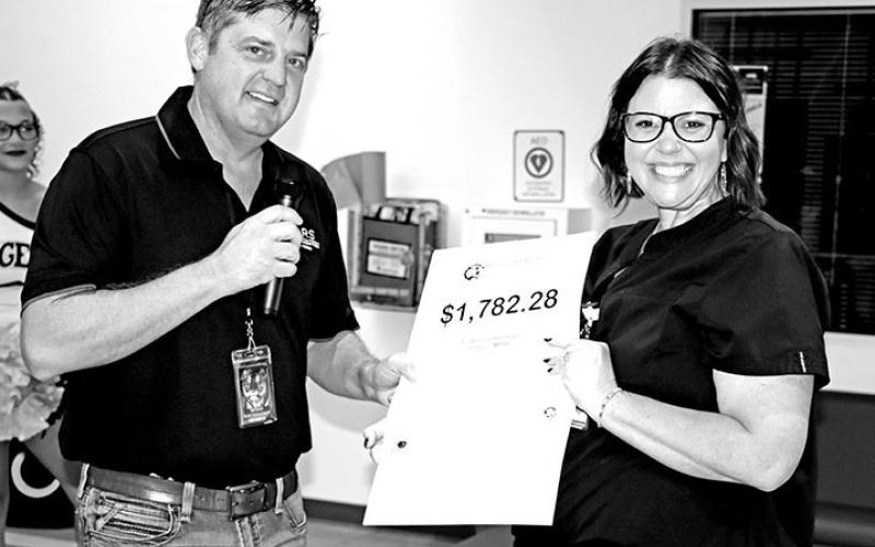 Dr. Kenny Thompson awards a grant to MPHS Health Science teacher, Amanda Hutchings COURTESY PHOTOS