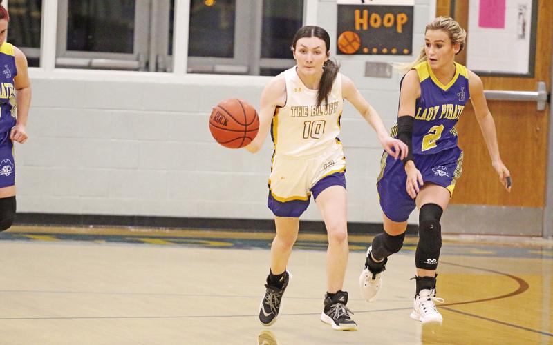 Harts Bluff’s Kaitley Green kicks off a fast break ahead of James Bowie’s Madison Martin during Friday’s district opener. The Lady Bulldogs fell to the Lady Pirates, 49-35. Harts Bluff hosted Detroit Tuesday and travel to Clarksville Friday. TRIBUNE PHOTO / QUINTEN BOYD