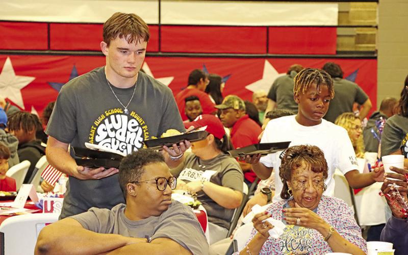 MPHS senior, Tanner Marshall (left), and Wallace fifth grader, Carmelo Green, serve the veterans and their families