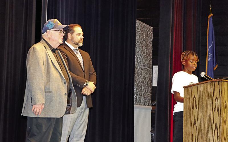 Wallace 5th grader, Carmelo Green (right), and Wallace Principal, Nathan Rider (center) introduce and welcome the guest speaker, Louie J. Barton