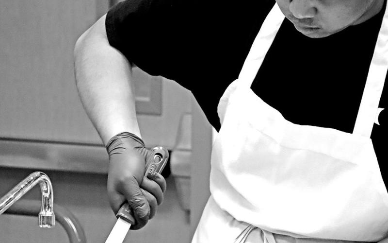 Kurt Alipao prepares the homemade macaroni and cheese