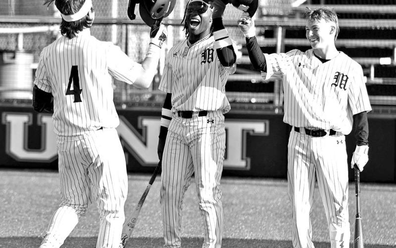 Mount Pleasant’s Drew Cross (4) is greeted at home plate by teammates after belting a home run during a recent home game. COURTESY PHOTOS