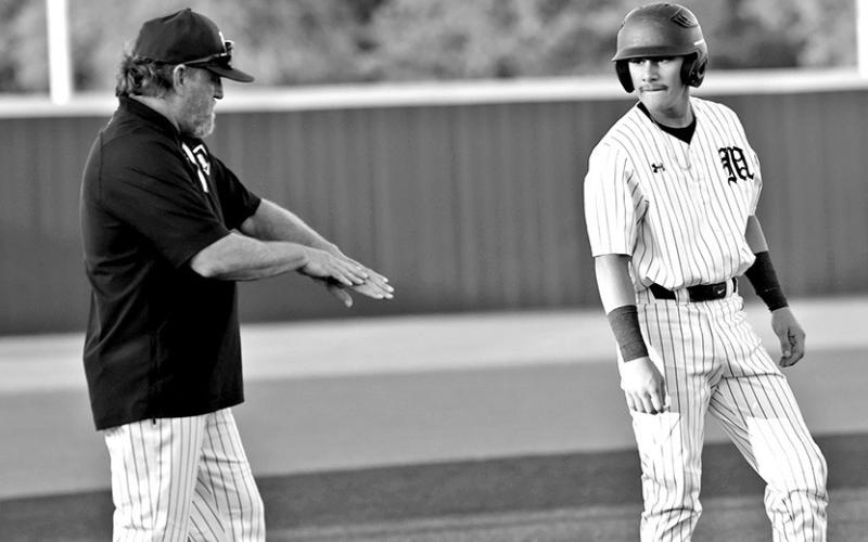Mount Pleasant head baseball coach Tommy Stewart gives signs during a recent home game.