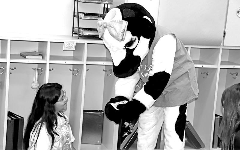 The Chick-Fil-A Cow talks to Zayleigh Duron at Vivian Fowler