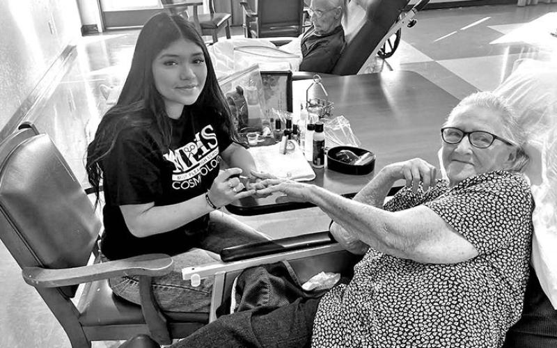 Yoselin Lopez (left) paints Mary Thompson’s nails