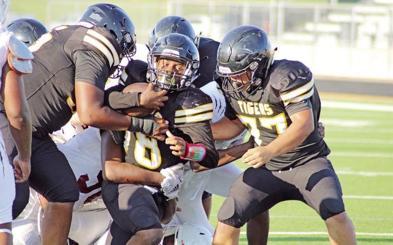 With help from his offensive line, Mount Pleasant’s Omari Peters powers through the Liberty-Eylau defense during Thursday’s game. The freshmen Tigers defeated the Leopards, 26-0. TRIBUNE PHOTO / QUINTEN BOYD
