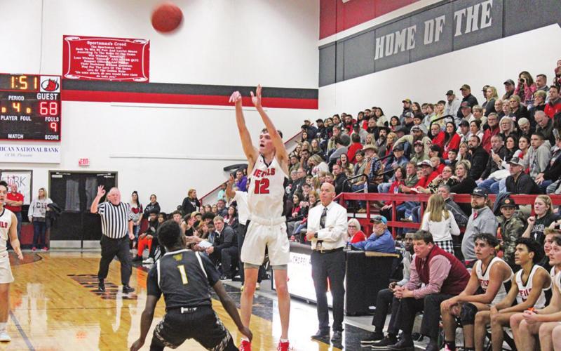 Casey House puts up a three-pointer during the Red Devils’ game against Timpson. TRIBUNE PHOTOS / QUINTEN BOYD