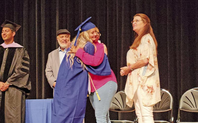 Graduates of Mount Pleasant Dental Assistant School walk the stage