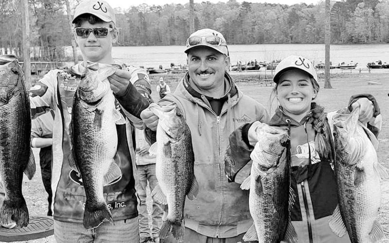 High school anglers Mason McCormick (left) and Alexis Virgillito (right) recently weighed in a 37.13-pound limit in a Louisiana Bass Nation high school tournament on Caney Lake. It may be the heaviest single day weight ever recorded in high school fishing tournaments. The young anglers were captained by Brad Virgillito (center). COURTESY PHOTO