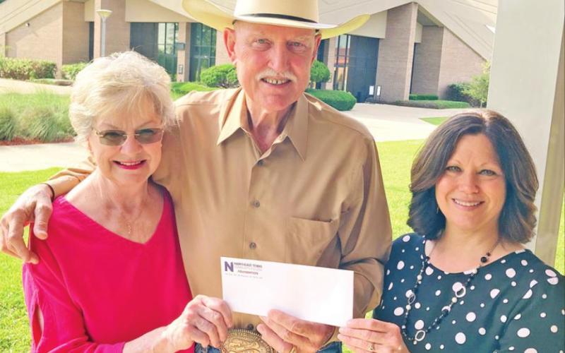 Pictured above, the Fosters present their donation to May (right). Pictured separately, members of Kappa Pi present their scholarship (from left): Bertie Ham, Nita May, Sherry Williams, Linda Blount, Suzanne Foster, Becky Tatman and Sharon Lumpkin. COURTESY PHOTO