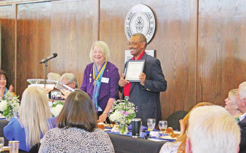 Carolyn Franks presents Pastor Robert Thompson (pictured) and Mike Groom with $100 donated to the Rotary Foundation in their names. GAZETTE PHOTO / ELIZABETH LANNING