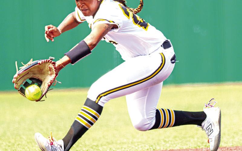 Lady Tiger shortstop Azzy Fluellen backhands a ground ball during the loss to Whitehouse.