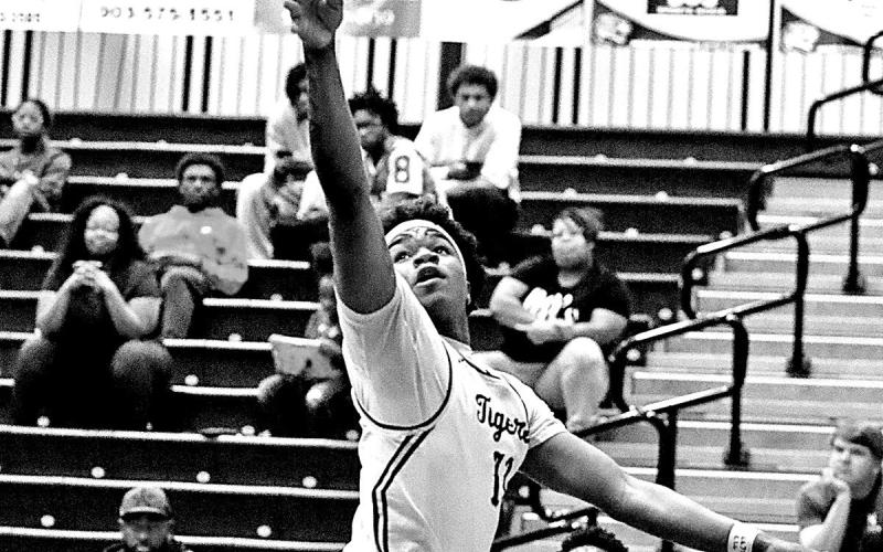 Zeke Hill floats a runner in traffic, finishing strong in the paint as Mt. Pleasant controlled the tempo against Nacogdoches.